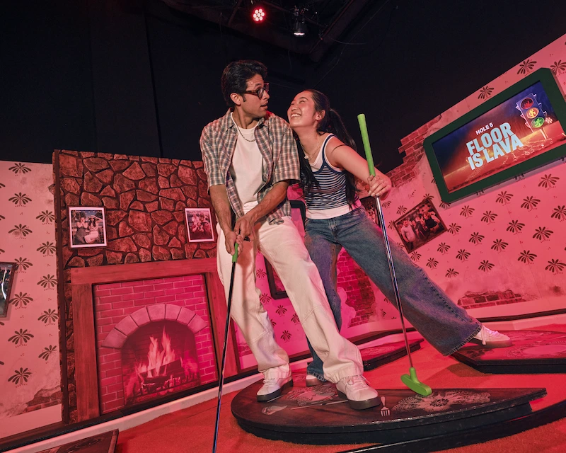 A couple playing mini golf in Top 9