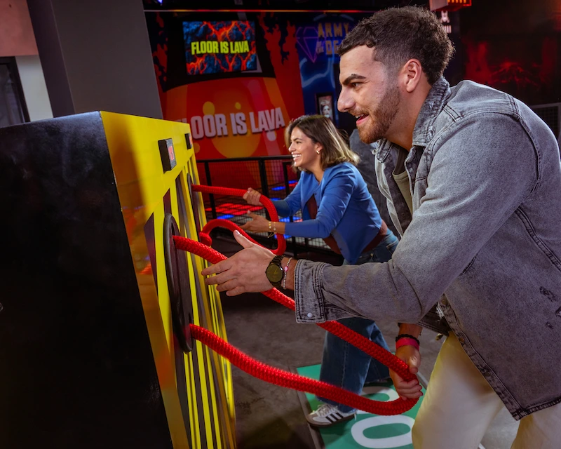 Man and Woman challenging each other in RePLAY game