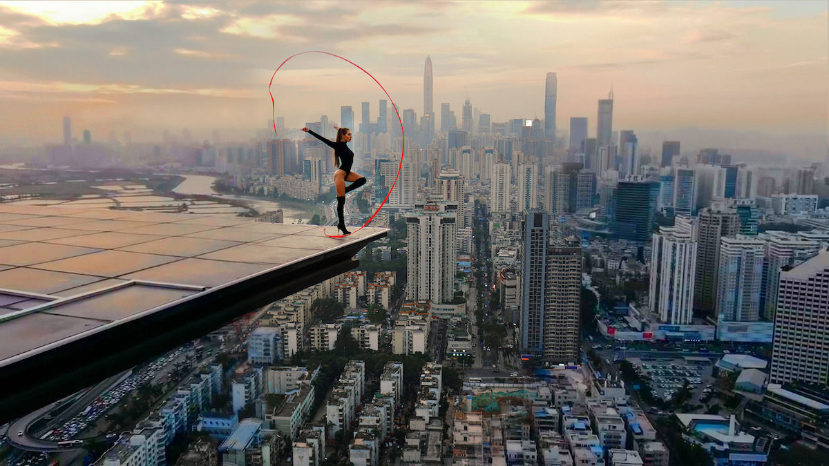 Angela Nikolau dancing at the edge of a building