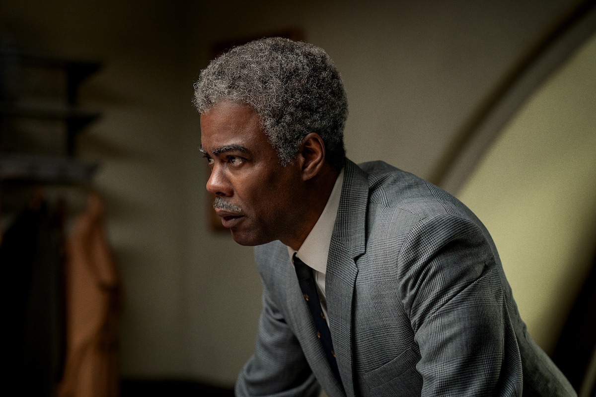 Chris Rock as Roy Wilkins wears a gray suit in ‘Rustin’