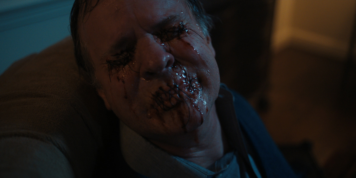Chrissy’s dad (Christopher Strand) mutilated and sewn into his chair - The ‘Stranger Things’ Makeup Team Does It All, from Fake Blood to ’80s Eyeshadow