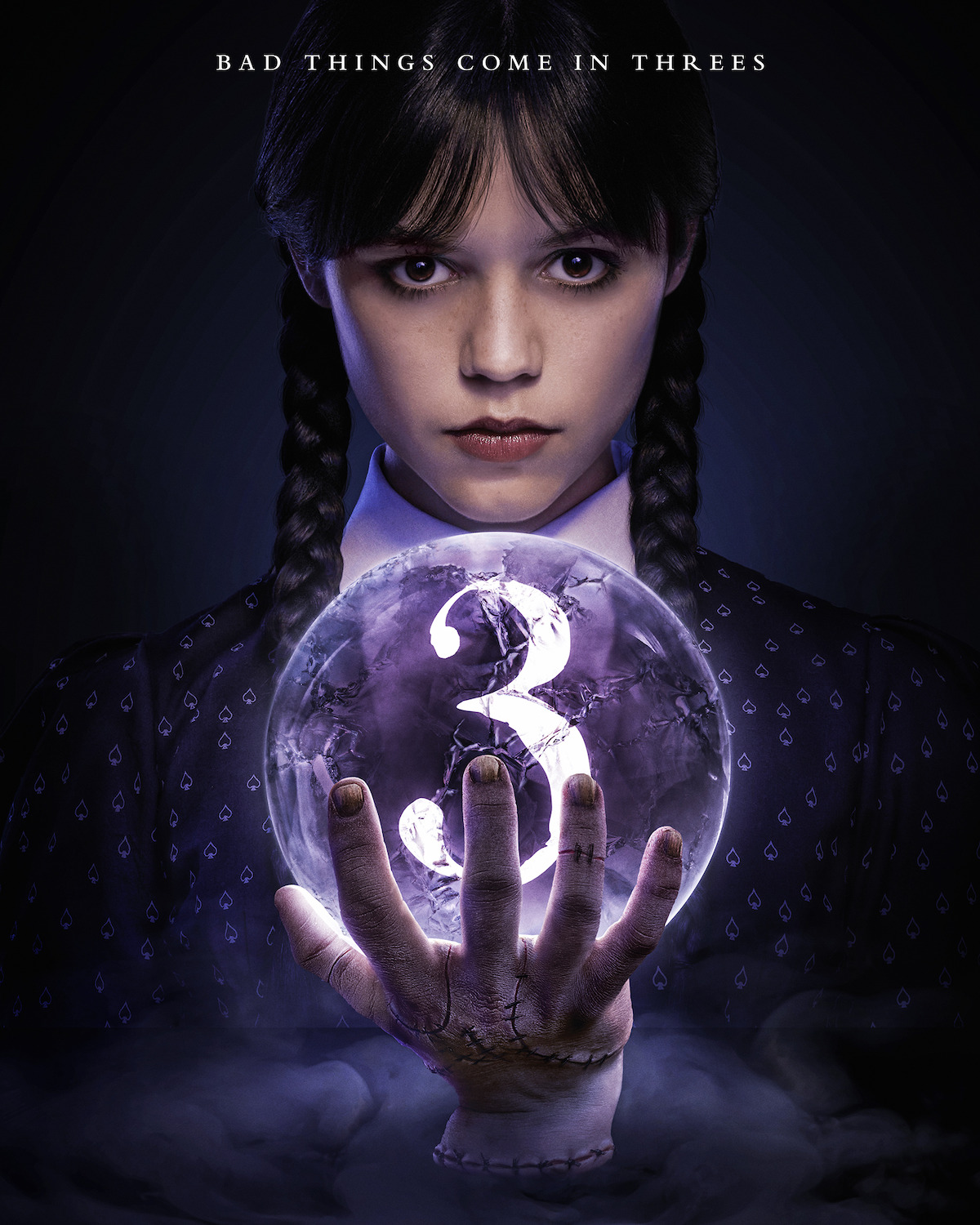 Wednesday Addams and Thing, holding a crystal ball with the number “3” inside of it.
