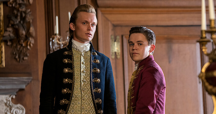 Reynolds and Brimsley stand next to each other in Queen Charlotte