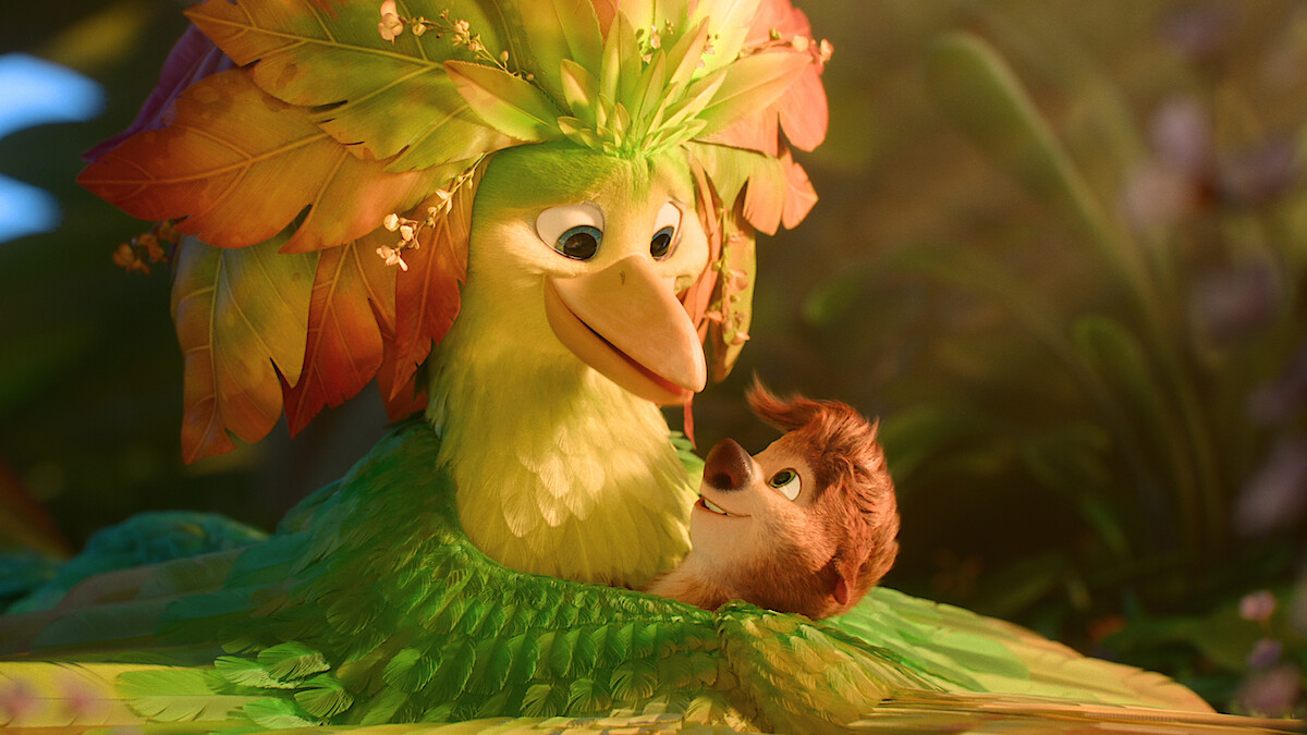 A colorful animated bird with leaf feathers lovingly embraces a small smiling animal in a lush, vibrant jungle environment with soft light and green foliage in the background.