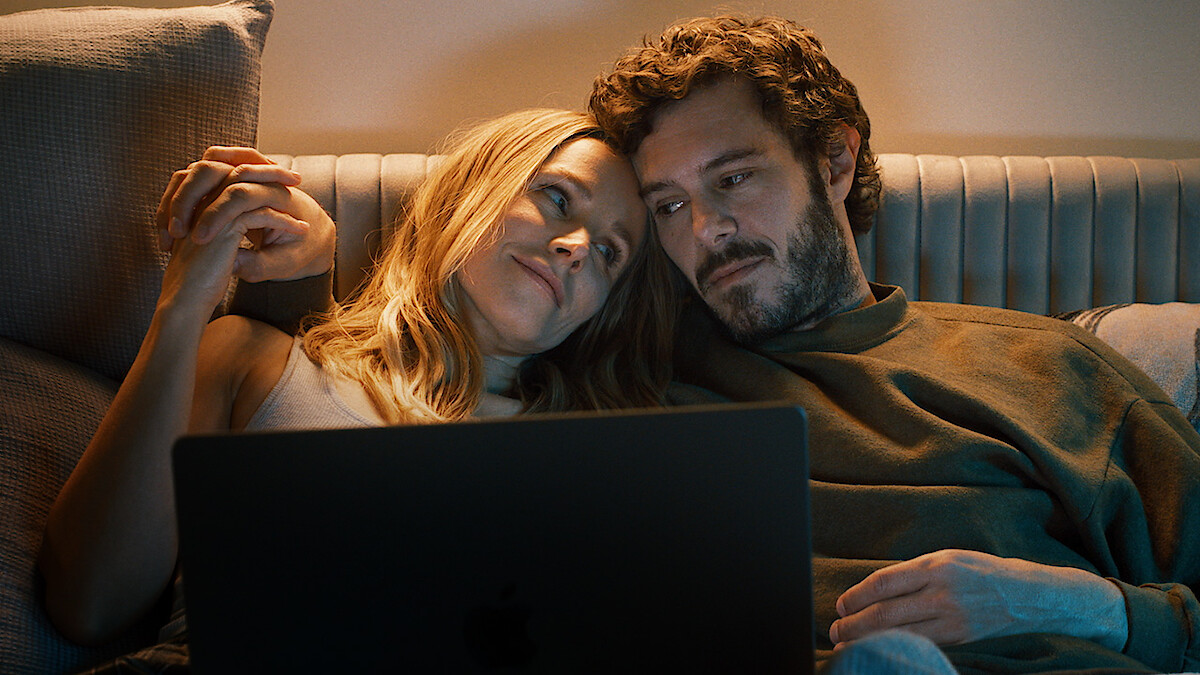 Kristen Bell as Joanne and Adam Brody as Noah snuggle on a couch together in Season 1 of 'Nobody Wants This'