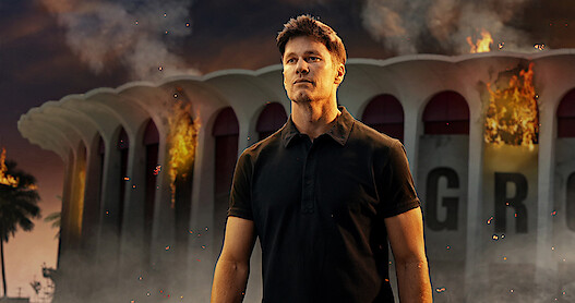 Tom Brady in front of a burning Kia Forum 