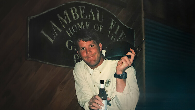 Brett Favre holding a beer and a helmet