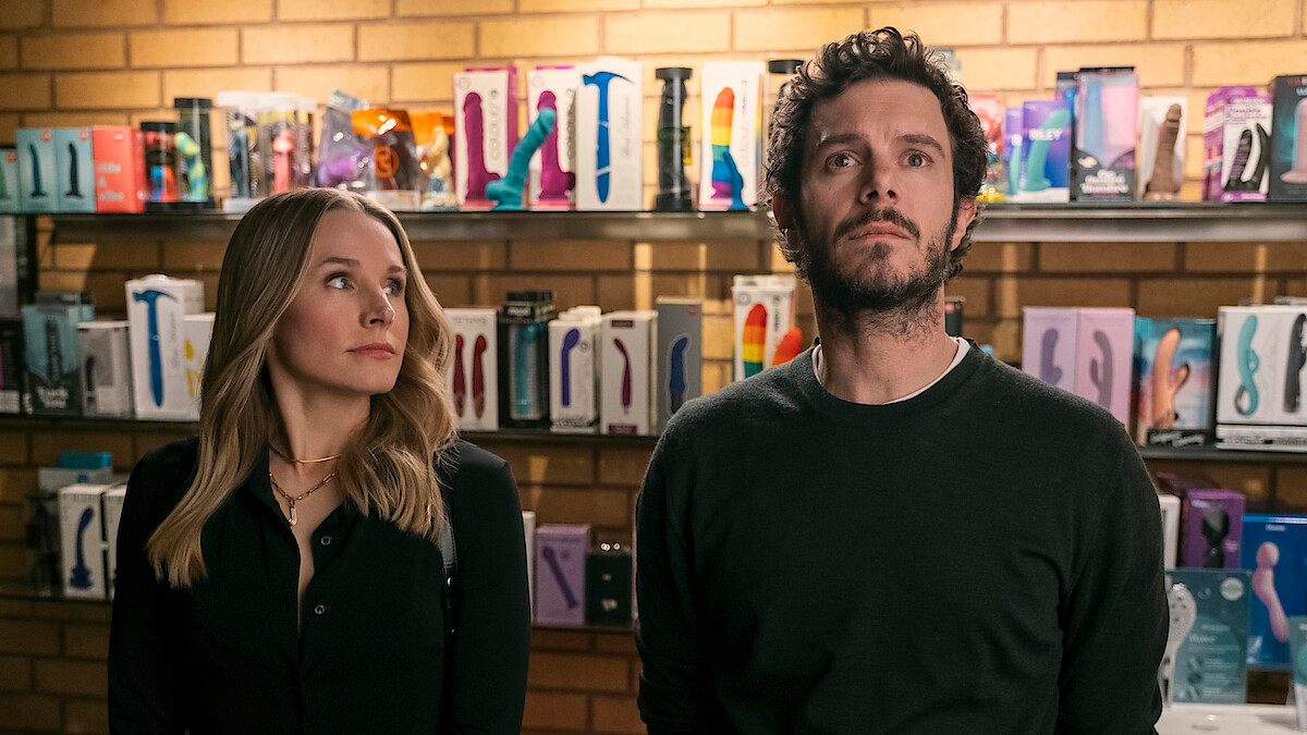 Kristen Bell as Joanne looks up at Adam Brody as Noah in a sex shop in Season 1 of 'Nobody Wants This'