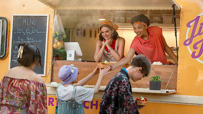 Zoey Deutch as Jill and Megan Danso as Zella sell dessert nachos at a food truck in 'Voicemails for Isabelle'