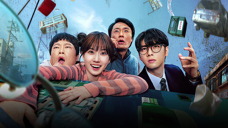 Four people with surprised expressions inside a tilting bus, floating debris and buildings in a chaotic city scene, suggesting an intense or supernatural event.