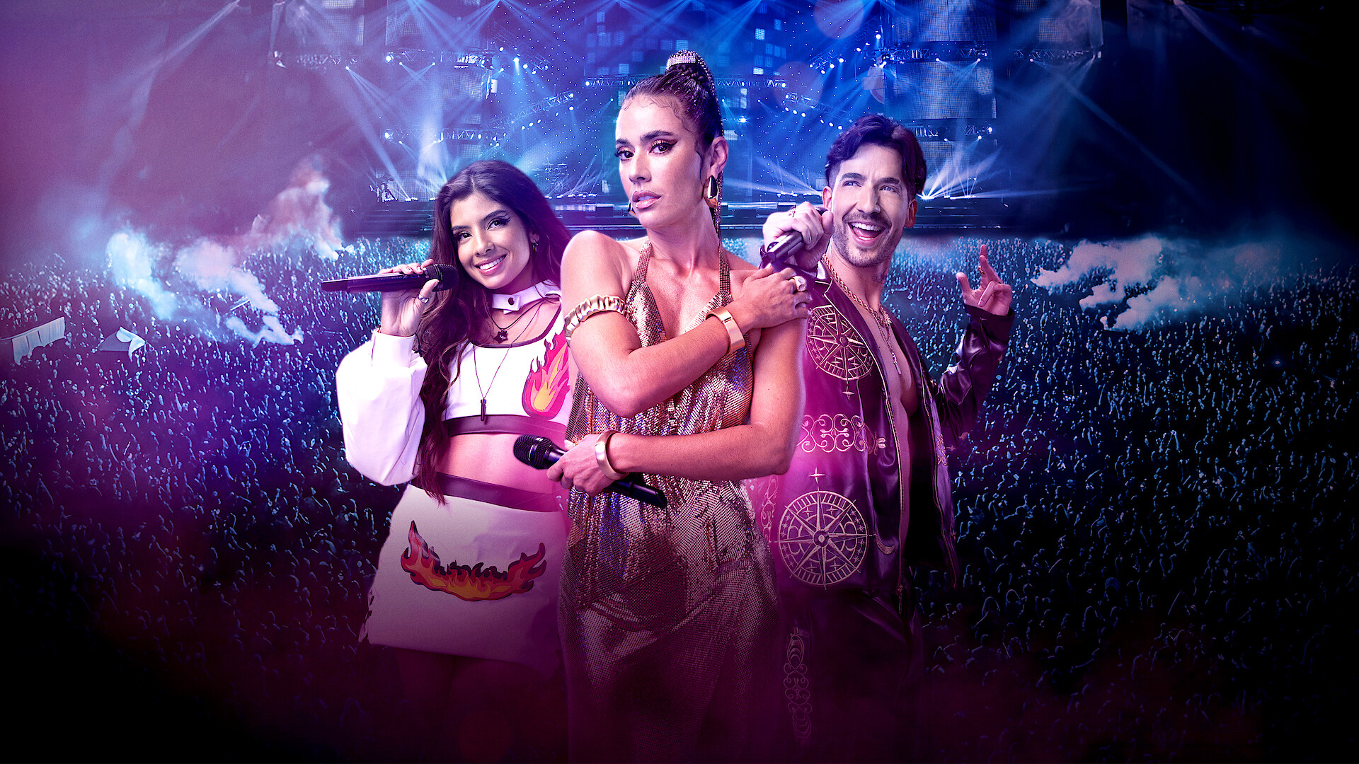 Three singers pose confidently on stage with microphones, dressed in vibrant performance outfits. Behind them, a cheering crowd and dramatic stage lights create a lively concert atmosphere.